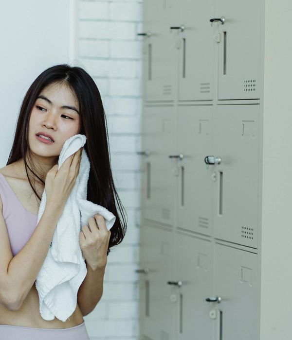 Person smiling and looking refreshed after a light workout session.